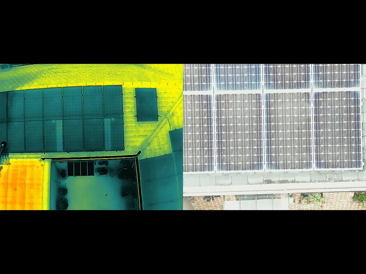 Opérateur tenant une caméra thermique professionnelle devant un mur avec échelle de températures affichée